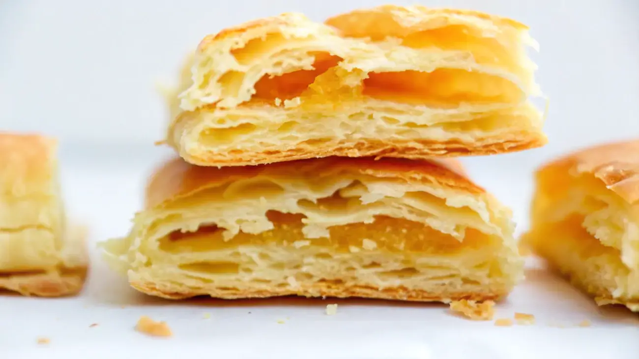 Gluten-free puff pastry dough being folded for a flaky texture