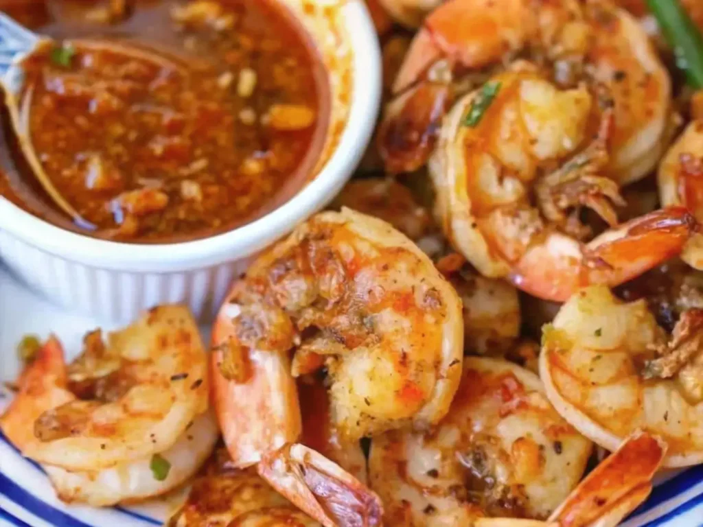 Seafood boil platter with sauce drizzled over shrimp and crab legs