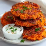 Crispy shredded sweet potato fritters served with creamy dipping sauce and parsley garnish