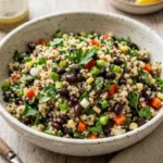 Colorful black bean quinoa salad with fresh vegetables and dressing
