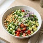 Vibrant chickpea salad with fresh vegetables and herbs in a bowl