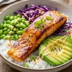 Delicious honey glazed salmon rice bowl with colorful vegetables