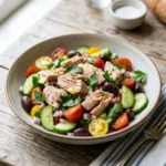 Mediterranean tuna salad with fresh vegetables and herbs in a bowl