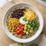 Healthy quinoa taco bowl with fresh vegetables and toppings