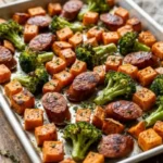 Roasted sweet potatoes, sausage, and broccoli on a sheet pan meal