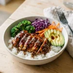 Delicious teriyaki chicken rice bowls topped with fresh vegetables and sauce