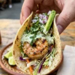 Cilantro lime shrimp tacos served with creamy slaw on a plate.