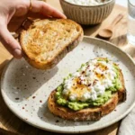 Cottage cheese avocado toast topped with fresh herbs and cherry tomatoes