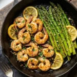 Lemon garlic shrimp sautéed with fresh asparagus in a vibrant dish