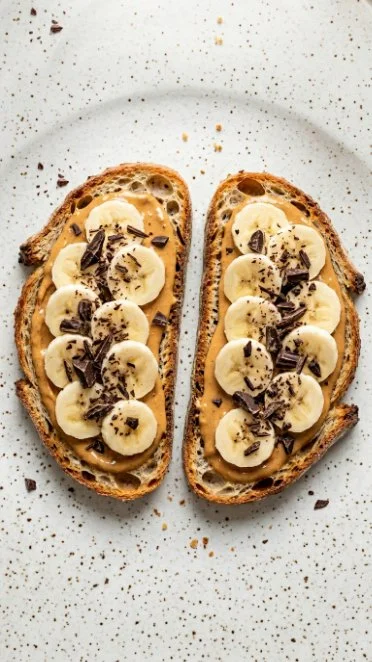 Peanut Butter Banana Toast with Dark Chocolate garnished with sliced bananas