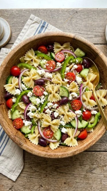 Colorful Greek Pasta Salad with vegetables, feta cheese, and olives