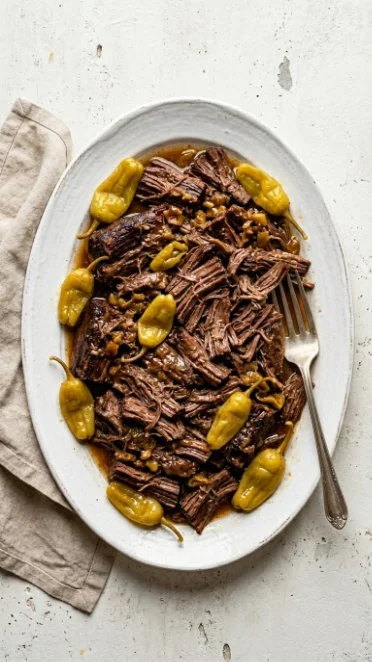 Delicious Mississippi Pot Roast served with vegetables in a rich sauce.