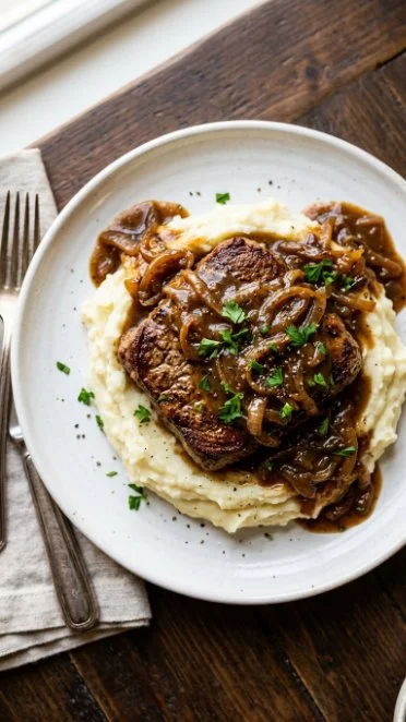 Crockpot cubed steaks with gravy served on a plate