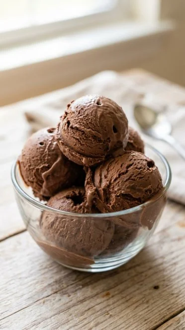 Bowl of homemade chocolate ice cream with chocolate shavings on top