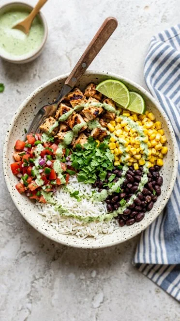 High protein chicken burrito bowl topped with fresh ingredients